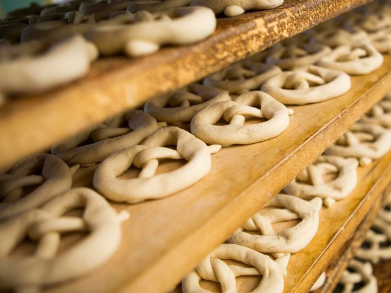 Hammond's sourdough pretzels resting on wooden racks. Hammond’s explains why genuine sourdough hard pretzels cannot be replicated by machine.